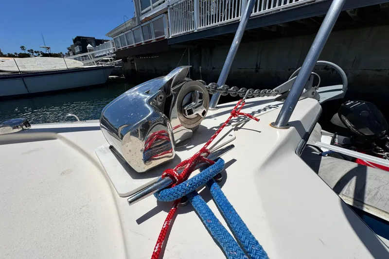 Slide: The Image of Bow of 2016 Defiance San Juan 250 with anchor chain and colorful ropes. - 2