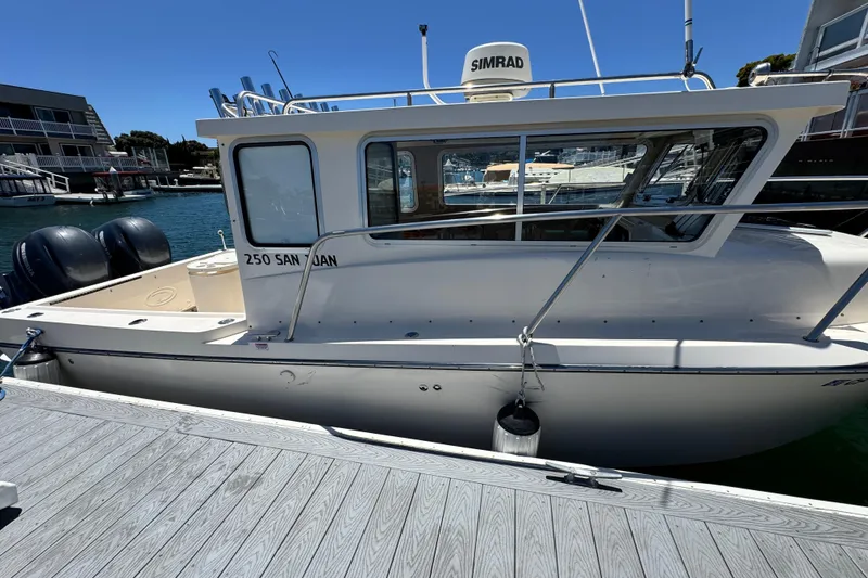 Slide: The Image of 2016 Defiance San Juan 250 boat docked at marina with dual engines. - 20
