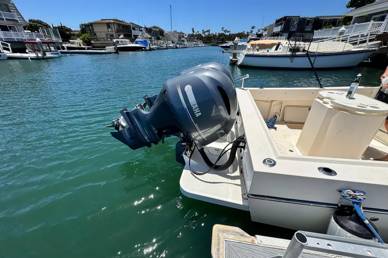 Slide: The Image of 2016 Defiance San Juan 250 boat with Yamaha outboard motor in a marina setting. - 26