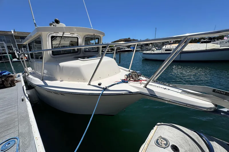 Slide: The Image of 2016 Defiance San Juan 250 boat docked in a marina under clear blue skies. - 27