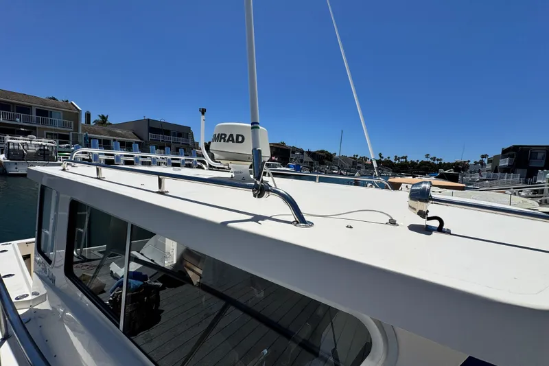 Slide: The Image of 2016 Defiance San Juan 250 boat docked, featuring radar equipment on the roof. - 28