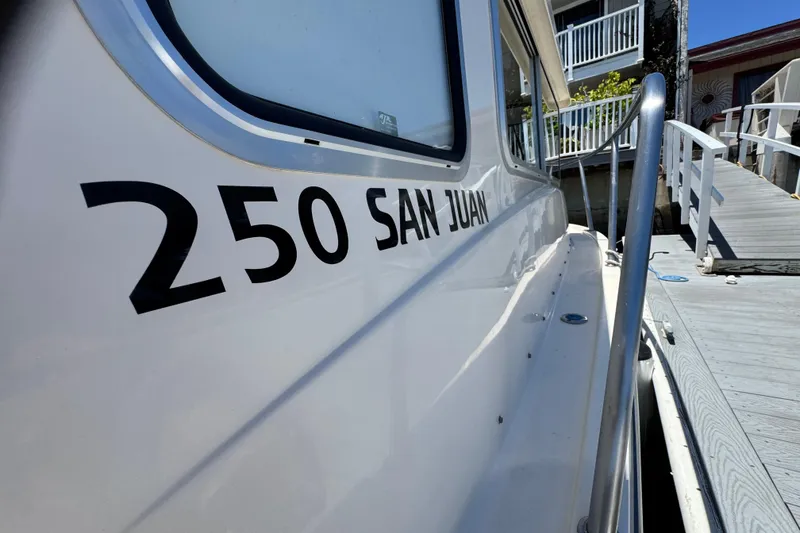 Slide: The Image of 2016 Defiance San Juan 250 boat docked at a marina. - 29