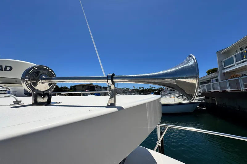 Slide: The Image of 2016 Defiance San Juan 250 boat horn against clear blue sky in marina. - 3