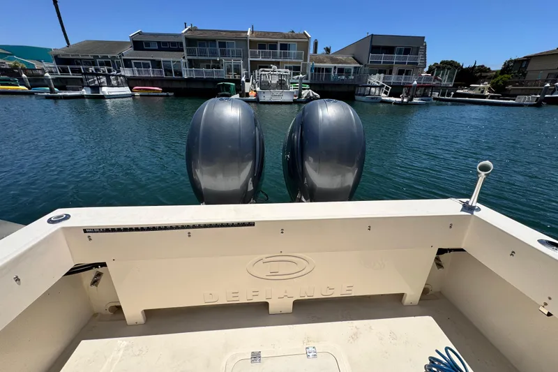 Slide: The Image of 2016 Defiance San Juan 250 boat with dual engines docked in a marina. - 30
