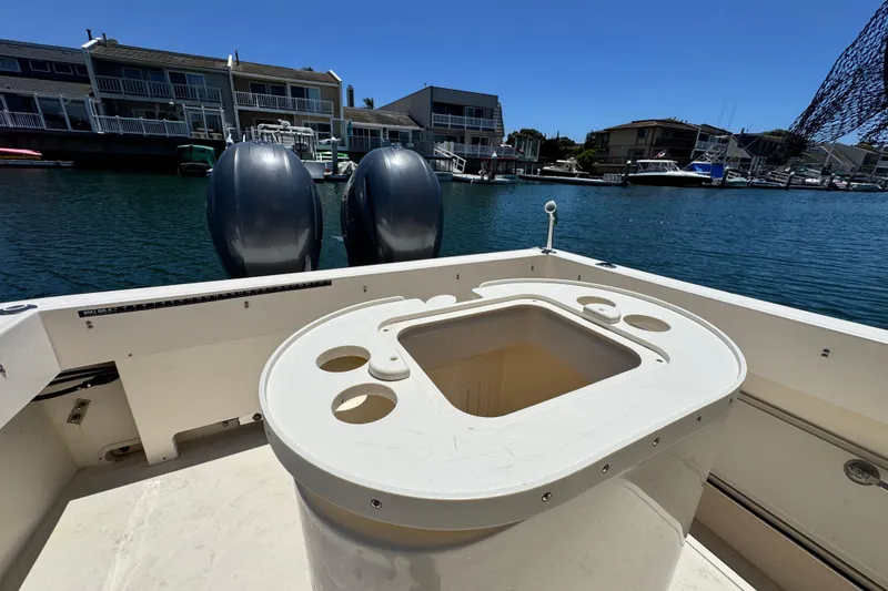 Slide: The Image of 2016 Defiance San Juan 250 boat with dual engines docked in a marina. - 32