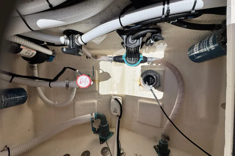 Slide: The Image of 2016 Defiance San Juan 250 boat interior showing plumbing and wiring components. - 36