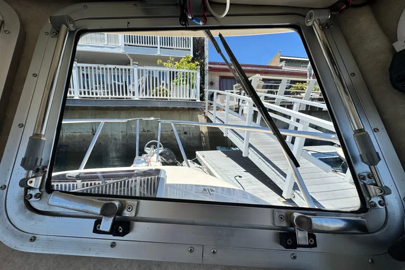 Slide: The Image of View from inside a 2016 Defiance San Juan 250 boat, showing dock and railing. - 39