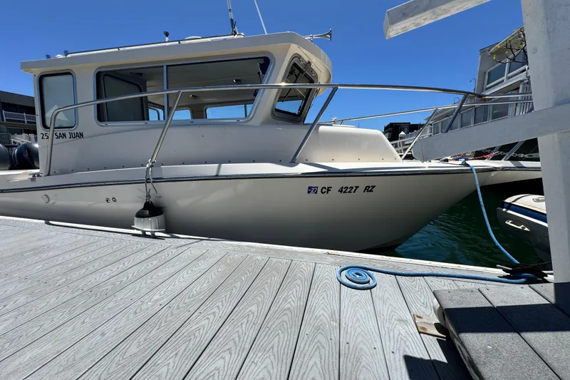 Slide: The Image of 2016 Defiance San Juan 250 boat docked at marina under clear blue sky. - 4