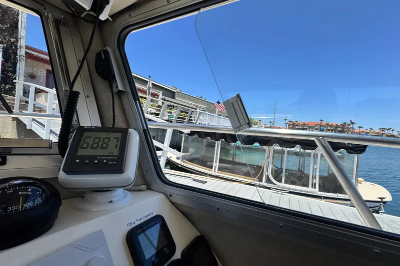 Slide: The Image of Interior view of a 2016 Defiance San Juan 250 boat with navigation instruments. - 40