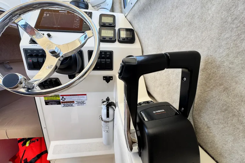 Slide: The Image of 2016 Defiance San Juan 250 boat cockpit with steering wheel and Yamaha controls. - 41