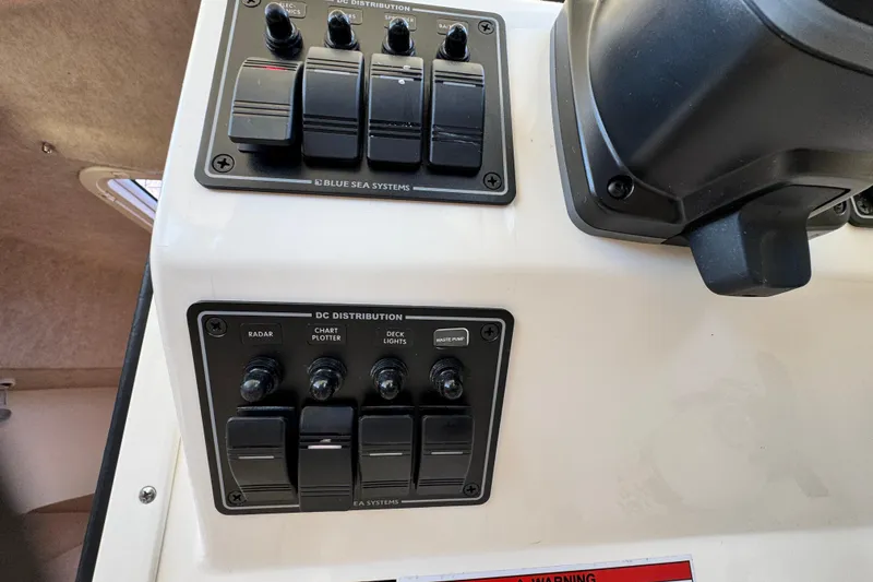 Slide: The Image of Control panel of a 2016 Defiance San Juan 250 boat with DC distribution switches. - 42