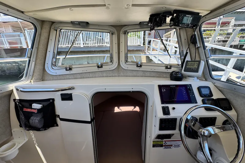 Slide: The Image of Interior view of 2016 Defiance San Juan 250 boat cockpit with navigation equipment. - 45