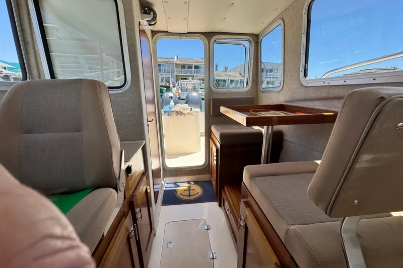 Slide: The Image of Interior of a 2016 Defiance San Juan 250 boat with seating and table. - 47
