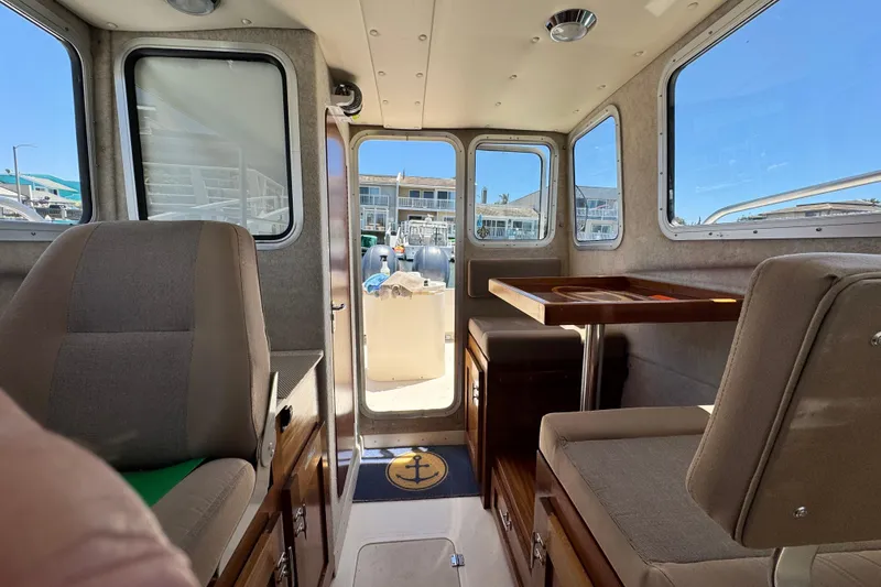 Slide: The Image of Interior of a 2016 Defiance San Juan 250 boat with seating and table. - 48