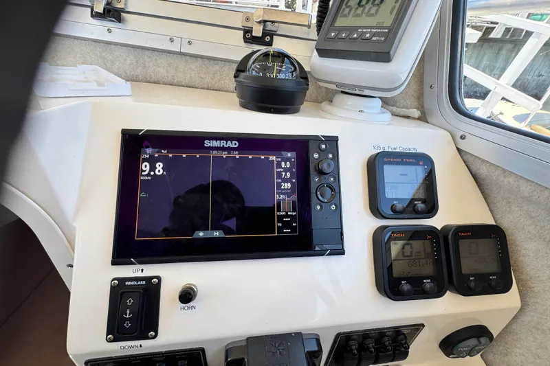 Slide: The Image of 2016 Defiance San Juan 250 boat dashboard with Simrad navigation and digital gauges. - 51