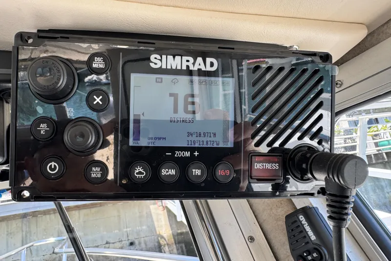 Slide: The Image of Simrad marine radio on 2016 Defiance San Juan 250, displaying distress signal coordinates. - 52