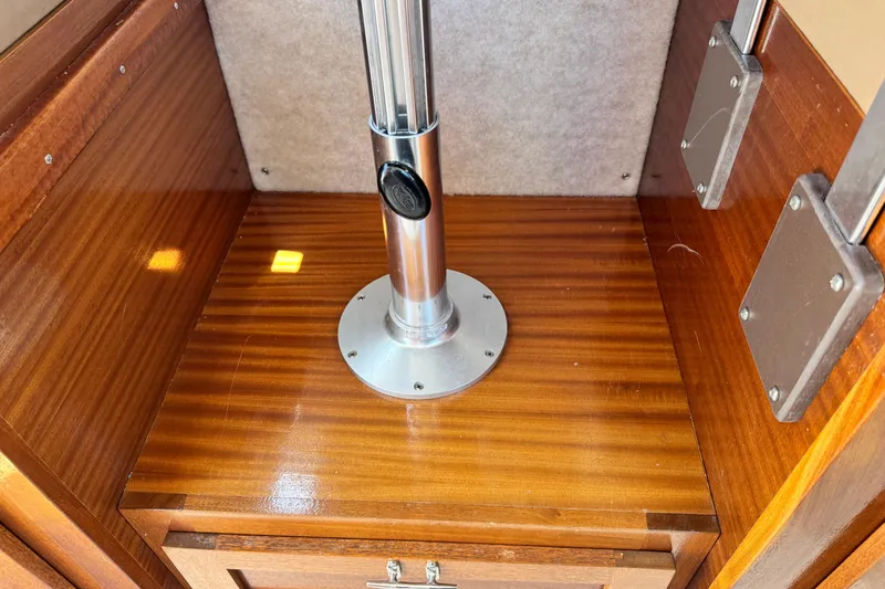 Slide: The Image of Interior of 2016 Defiance San Juan 250 boat with polished wood and metal fixtures. - 53