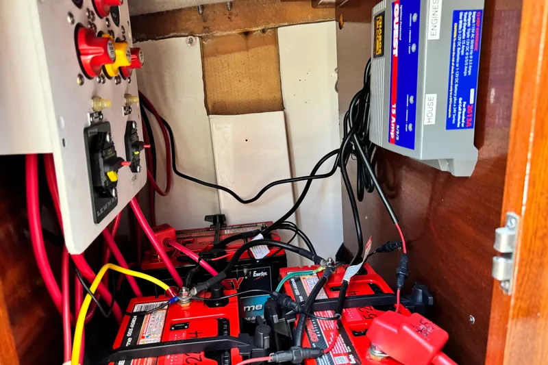 Slide: The Image of Electrical system inside a 2016 Defiance San Juan 250 boat, featuring batteries and wiring. - 57