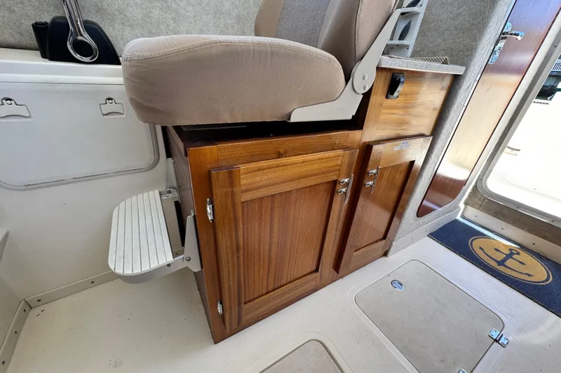 Slide: The Image of Interior of 2016 Defiance San Juan 250 boat with wooden cabinetry and seating. - 7