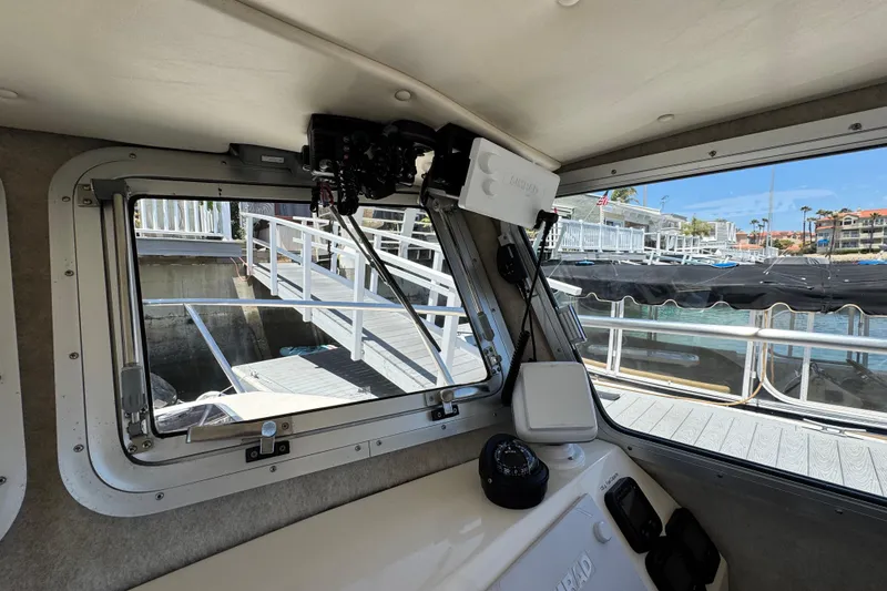 Slide: The Image of Interior view of a 2016 Defiance San Juan 250 boat, showing dockside marina. - 8