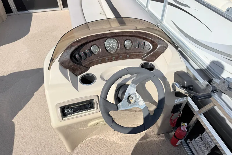 Slide: The Image of Steering console of a 2010 Bennington 20SLi pontoon boat with gauges and controls. - 12