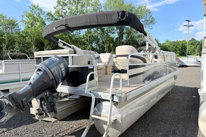Slide: The Image of 2010 Bennington 20SLi pontoon boat with Yamaha outboard motor, parked outdoors. - 4