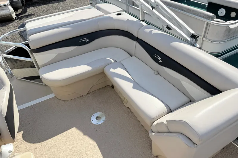 Slide: The Image of 2010 Bennington 20SLi boat interior with beige and black seating. - 7