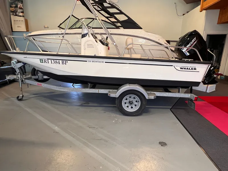 Slide: The Image of Boston Whaler 150 Montauk 2023 on trailer in garage. - 1