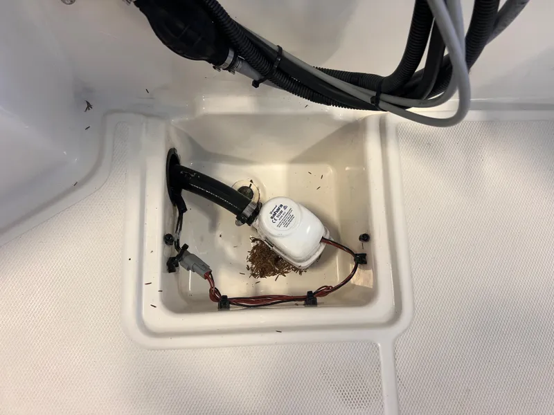 Slide: The Image of Boston Whaler 150 Montauk 2023, interior view with cables and debris. - 10