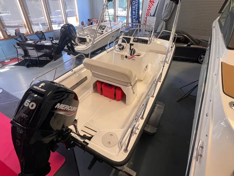 Slide: The Image of Boston Whaler 150 Montauk 2023 in showroom with Mercury 60 HP engine. - 16