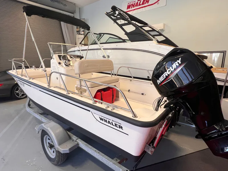 Slide: The Image of Boston Whaler 150 Montauk 2023 on trailer in garage. - 2