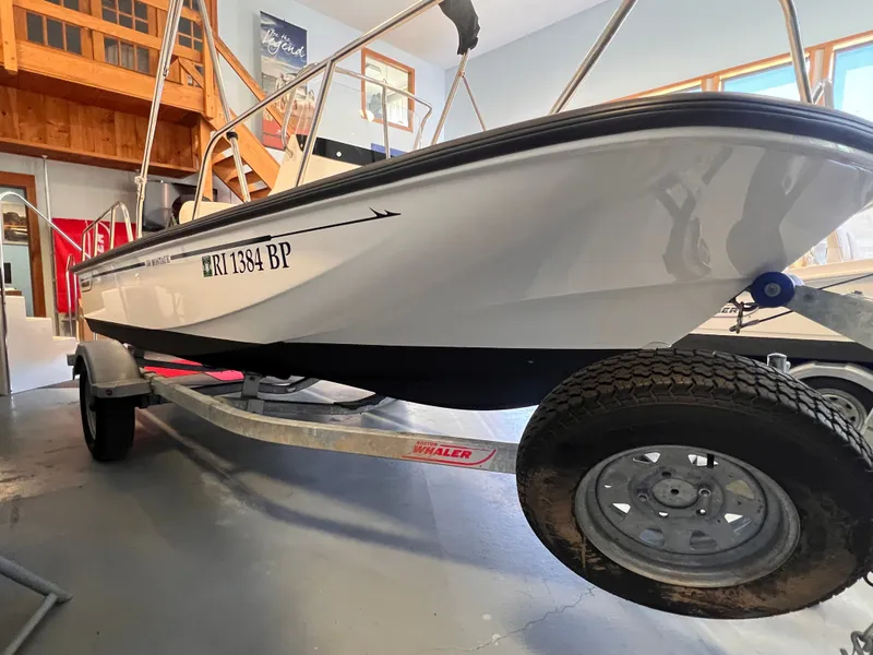 Slide: The Image of Boston Whaler 150 Montauk 2023 on trailer in garage. - 20