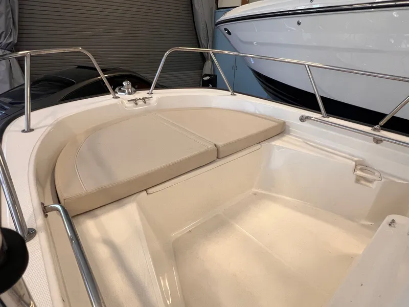 Slide: The Image of Boston Whaler 150 Montauk 2023 with cushioned seating area. - 4
