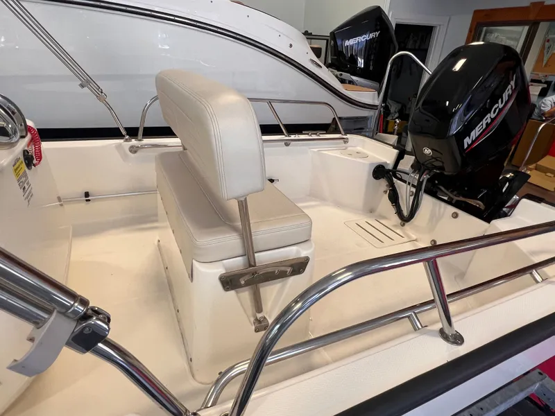 Slide: The Image of Interior of a 2023 Boston Whaler 150 Montauk with Mercury engine. - 5