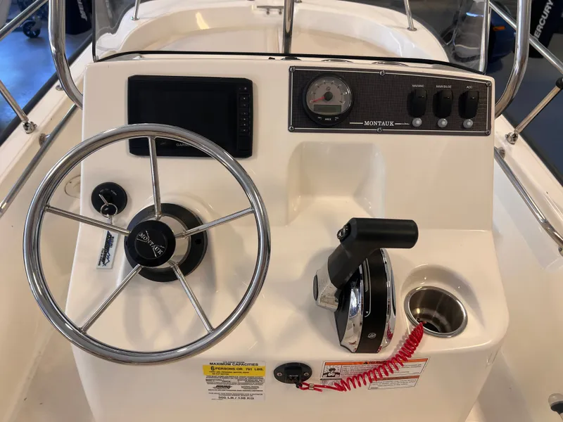Slide: The Image of Steering console of a 2023 Boston Whaler 150 Montauk boat. - 6