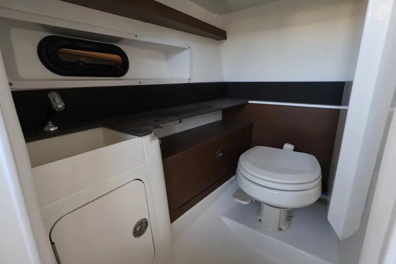 Slide: The Image of Interior of the 2027 Sea Ray SDX 290 Outboard featuring a toilet and sink. - 19