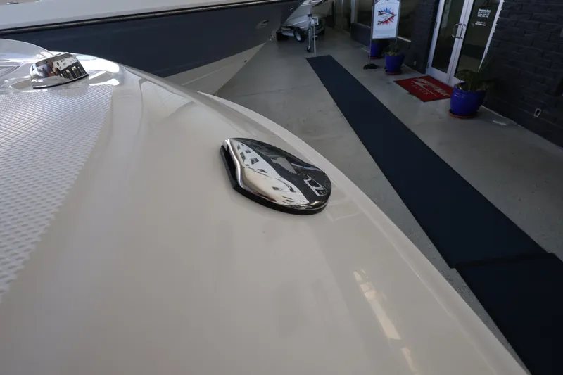 Slide: The Image of Close-up of a shiny boat deck with a Sea Ray logo in a showroom. - 32