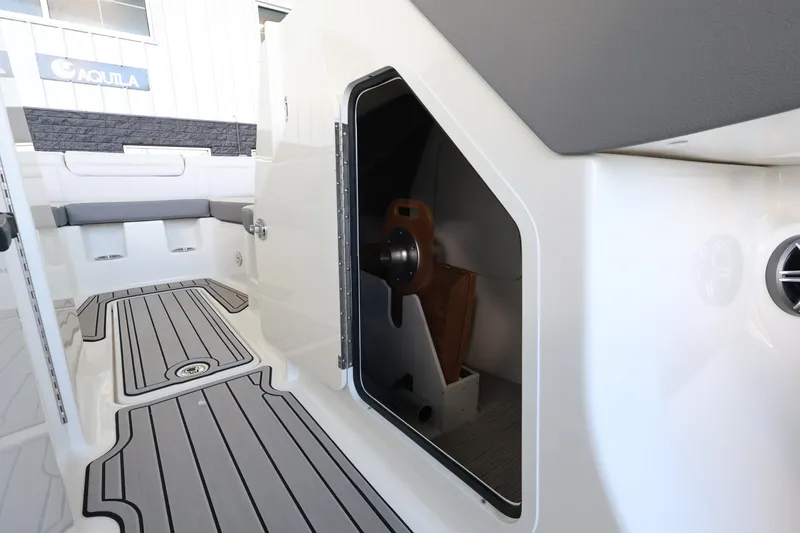 Slide: The Image of The 2027 Sea Ray SDX 290 Outboard features an open storage compartment with gray flooring. - 26