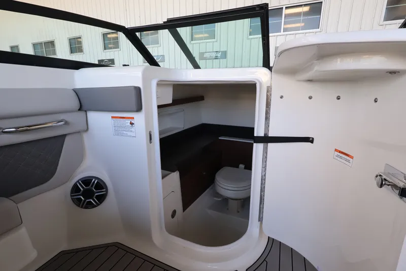 Slide: The Image of Interior view of a Sea Ray SDX 290 Outboard featuring a small toilet and seating area. - 18