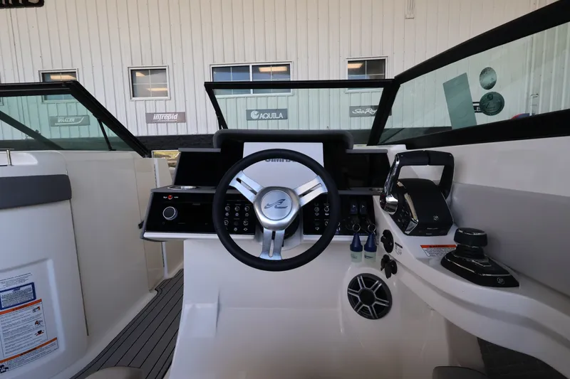 Slide: The Image of The image shows the helm of a 2027 Sea Ray SDX 290 Outboard with modern controls. - 22