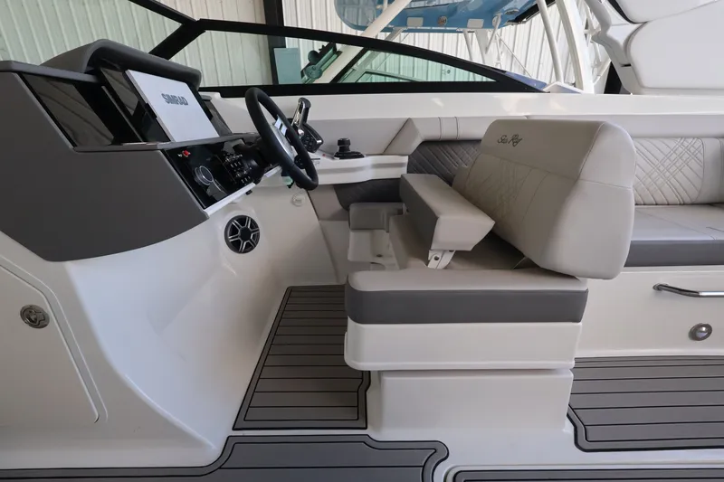 Slide: The Image of The image shows the cockpit of a 2027 Sea Ray SDX 290 Outboard with modern instruments and comfortable seating. - 21