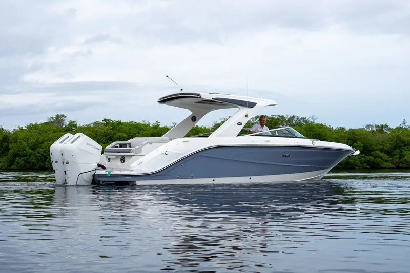 Slide: The Image of A sleek, modern motorboat with dual outboard engines on calm water, surrounded by green vegetation. - 3