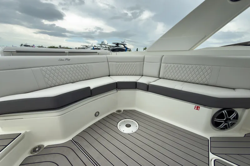Slide: The Image of The image shows the spacious cockpit of a Sea Ray SLX 310 Outboard with elegant upholstery. - 12