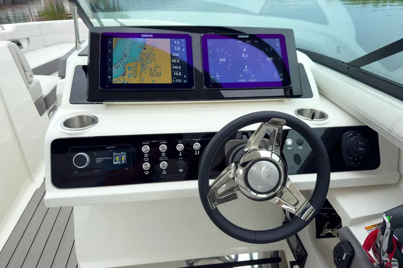 Slide: The Image of The image shows the helm of a Sea Ray SLX 310 Outboard with modern navigation screens. - 16