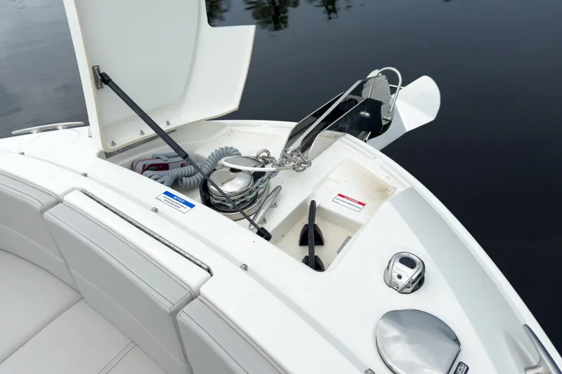 Slide: The Image of The 2027 Sea Ray SLX 310 Outboard features an open storage area with an anchor and accessories. - 24