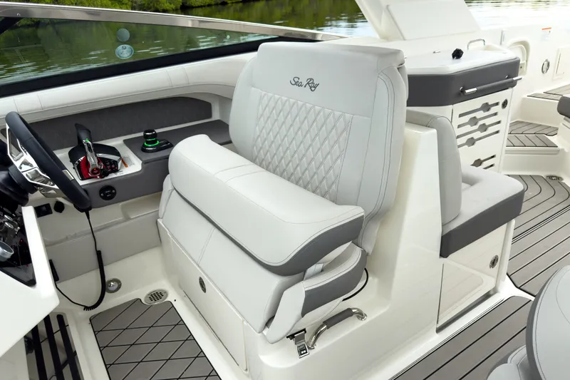 Slide: The Image of Luxurious helm of the Sea Ray SLX 310 Outboard with cushioned seating and modern controls. - 15