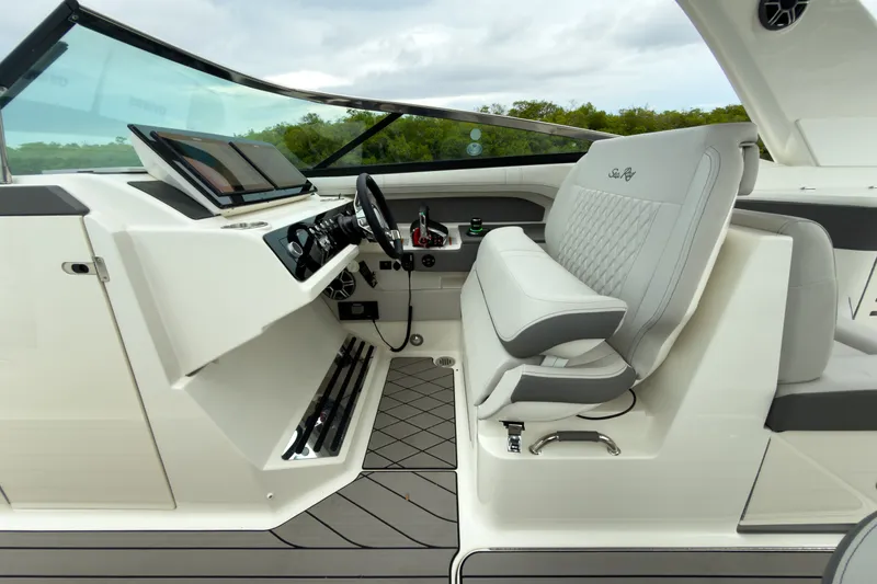 Slide: The Image of The image shows the cockpit of a 2027 Sea Ray SLX 310 Outboard with luxurious seating and modern electronics. - 13