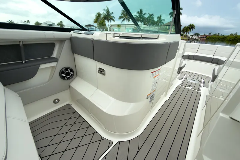 Slide: The Image of The image shows the interior of a Sea Ray SLX 310 Outboard with sleek seating and wood flooring. - 18