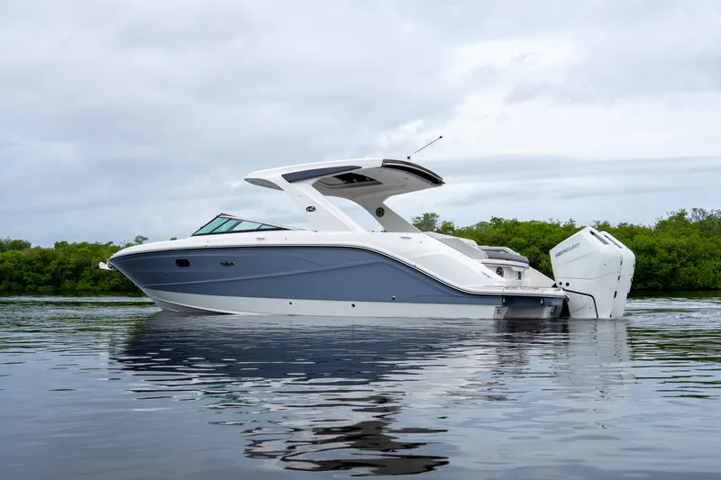 Slide: The Image of A sleek 2027 Sea Ray SLX 310 Outboard boat on calm water. - 1