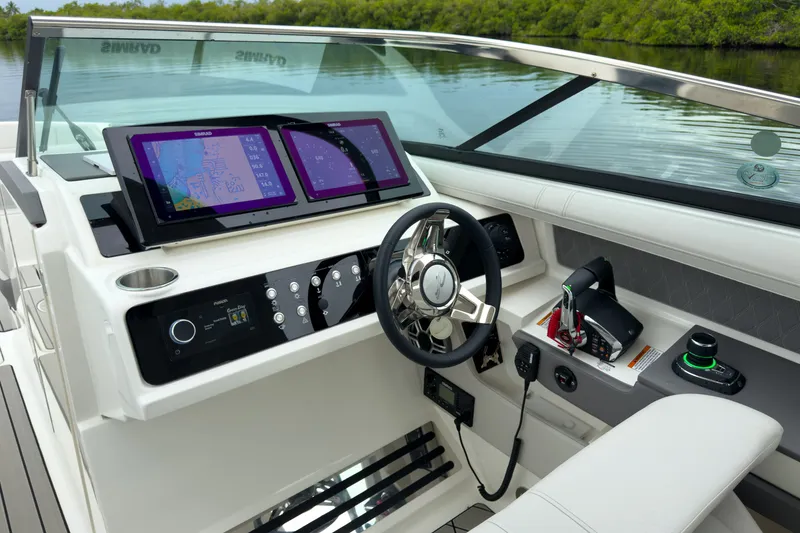 Slide: The Image of The image shows the cockpit of a Sea Ray SLX 310 Outboard with modern navigation systems and controls. - 14
